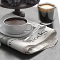 Warm Coffee Beverage in Ceramic Cup with Newspaper Muffin Coffee Beans and Grapes