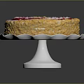 Round Decorative Cake With Red And White Cream Swirls And Yellow Crumbs On White Stand