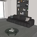 Modern Large Black Leather Sofa With Pillows In Living Room Glass Coffee Table And Bookshelf