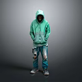 Man in Green Hoodie and Ripped Jeans Standing Against Gray Background with Sneakers