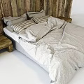 Double Bed With Wooden Plank Headboard Striped Pillows Light Patterned Duvet And Wooden Bedside Tables