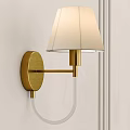 Golden Brass Wall Sconce With Beige Fabric Shade Curved Arm Mounted On White Wall