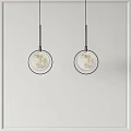Two Round Moon Pattern Pendant Lights With Black Frame Hanging On White Wall 3d model