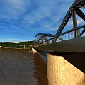 Steel Bridge Structure With Blue Sky People Walking And Road Surface Shadows
