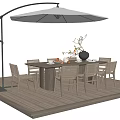 Round Outdoor Dining Table With Wicker Chairs Wooden Deck And Patio Umbrella