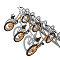 Three Silver Bicycles with Orange Wheels Parked at Metal Bicycle Rack