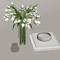 Clear Glass Vase With White Tulips Stack Of Books Gray Round Dish And Black Jar