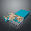 Open Blue Matchbox With Scattered Wooden Matches Blue Tips On Dark Surface