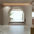 Bright Hotel Public Lounge Area With Arched Doorway Beige Walls Plant Armchair And Fireplace