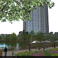 Urban Park Landscape With Lake View Wooden Walkway Green Trees And High Rise Buildings