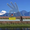 Rural Landscape With Giant White Palm Sculpture Wooden Platform Mountain Blue Sky And Waterfront Reeds