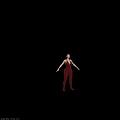 Woman in Crimson Red Jumpsuit with Arms Outstretched Against Black Background