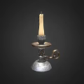 Decorative Metal Candle Holder With Lit Candle And Ornate Base Design