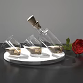 Elegant Transparent Glasses With Liquid Near Bottle And Red Rose On Marble Base