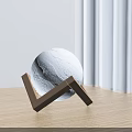 Modern White Spherical Table Lamp With Cracked Surface Wooden V Shaped Base And Natural Light