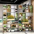 Modern Wooden Multi Compartment Shelving Unit In Bright Interior With Plants Books And Bottles