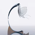 Modern Metallic Sculpture with Curved Structure and Butterfly Wing Design on Shiny Surface with Reflection