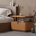 Wooden Bedroom Nightstand With Vase Green Plant And Stack Of Books