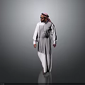 A Man In Traditional White Thobe And Pink Ghutra Standing Against Gray Background