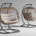 Two Modern Rattan Swing Chairs With White Cushions And Black Metal Frames