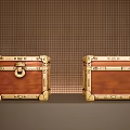 Two Brown Trunks with Gold Metal Latches and Decorations against Grid-Patterned Brown Wall 3d model