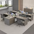 L Shaped Wooden Office Desks In Modern Workspace With Computer Monitors Files And Potted Plants