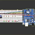 Microcontroller Development Board With Multiple Colored LED Lights And Connecting Wires