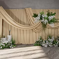 Elegant Banquet Hall Setup With Beige Drapery White Flowers And Greenery Decor