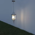 Outdoor White Pendant Light With Glass Shade Illuminated Over Grassy Lawn