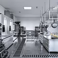 Commercial Kitchen With Stainless Steel Appliances Hanging Pots Worktables And Bright Lighting