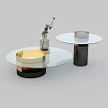 Round Glass Top Coffee Tables With Gold Black Brown Bases And Vase With Dried Flowers
