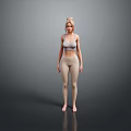 Woman in Gray Sports Bra and Beige Leggings Standing Barefoot on Reflective Floor