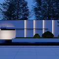 Modern Feature Wall With Illuminated Panels And Surrounding Greenery At Night