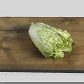 Fresh Chinese cabbage placed on wooden cutting board in bright white background