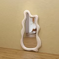 Light Colored Irregular Wavy Frame Mirror Hung On Beige Wall Reflecting Room Interior