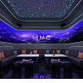Modern KTV Interior With Neon Lights Comfortable Seats Large Screen And Microphone