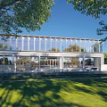 Modern Residential Building with Large Glass Walls and Lush Green Surrounding Lawns