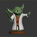 Green Yoda Toy Figure With White Robe Orange Outfit And Green Lightsaber On Orange Base