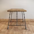 Rustic Wooden Dining Table With Metal Brackets Legs On Wooden Floor Interior