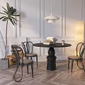 Modern Black Round Dining Table Set With Curved Chairs Green Plant And Floor Lamp