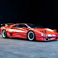 Red Sports Car With Sleek Aerodynamic Body And Rear Spoiler On Gray Floor