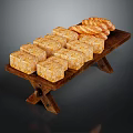 Golden Square Pastries and Twisted Bread Rolls Arranged on Wooden Tray