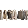 Stylish Neutral Tones Clothes Hanging On Wooden Hangers Including Shirts Vests And Sweaters