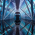 Amusement Park Indoor Attraction With Glass Dome Blue Lighting Reflective Floor And Geometric Frame Design