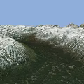 Mountainous Terrain With Snow Covered Peaks And Green Forested Valleys