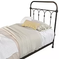 Single Bed with Black Iron Frame White Yellow Pillows Striped Sheets and Light Blanket