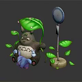 Brown Totoro Holding Small Blue Creature With Green Leaves And White Pole
