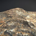 Desolate Rocky Mountain Landscape With Layered Terrain Gullies And Multicolored Hues In Brown Orange Blue