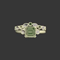 Gold ring adorned with square green gemstone and small white green surrounding decorative stones carved details