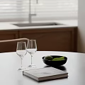 Cozy Kitchen Interior With Table Wine Glasses Bowl Green Fruits And Book